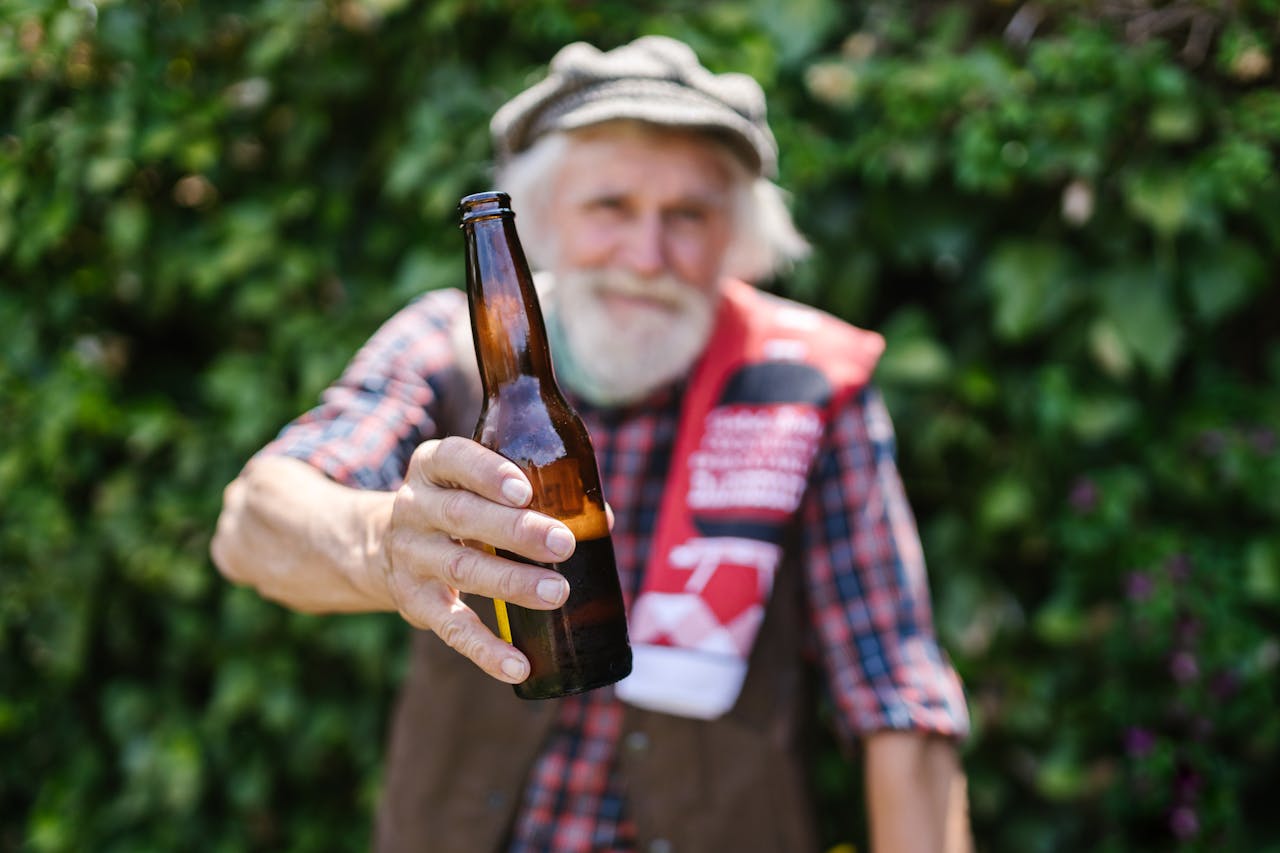 Selective Focus of a Man Holding a Beer Bottle